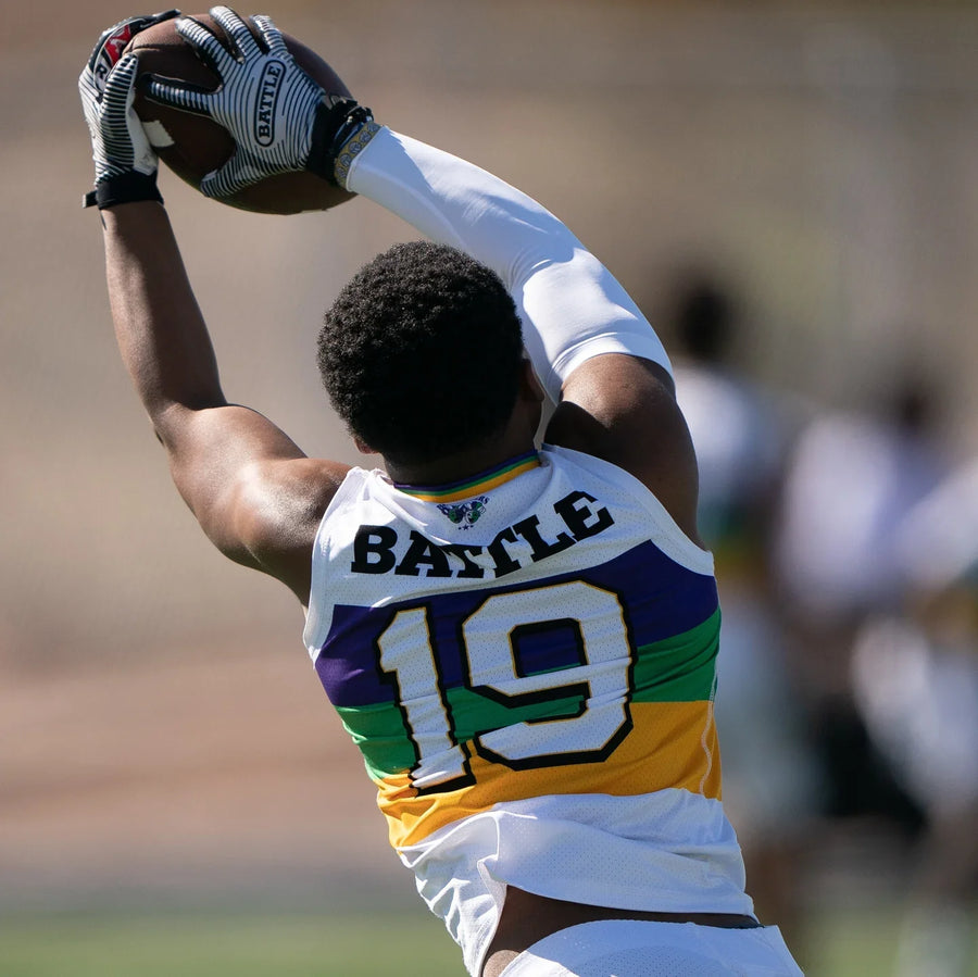 football player catching the ball with sticky gloves