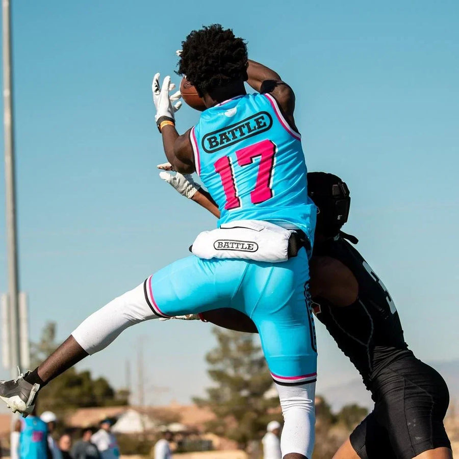 Battle Sports athlete jumping to catch the ball with a hand warmer on