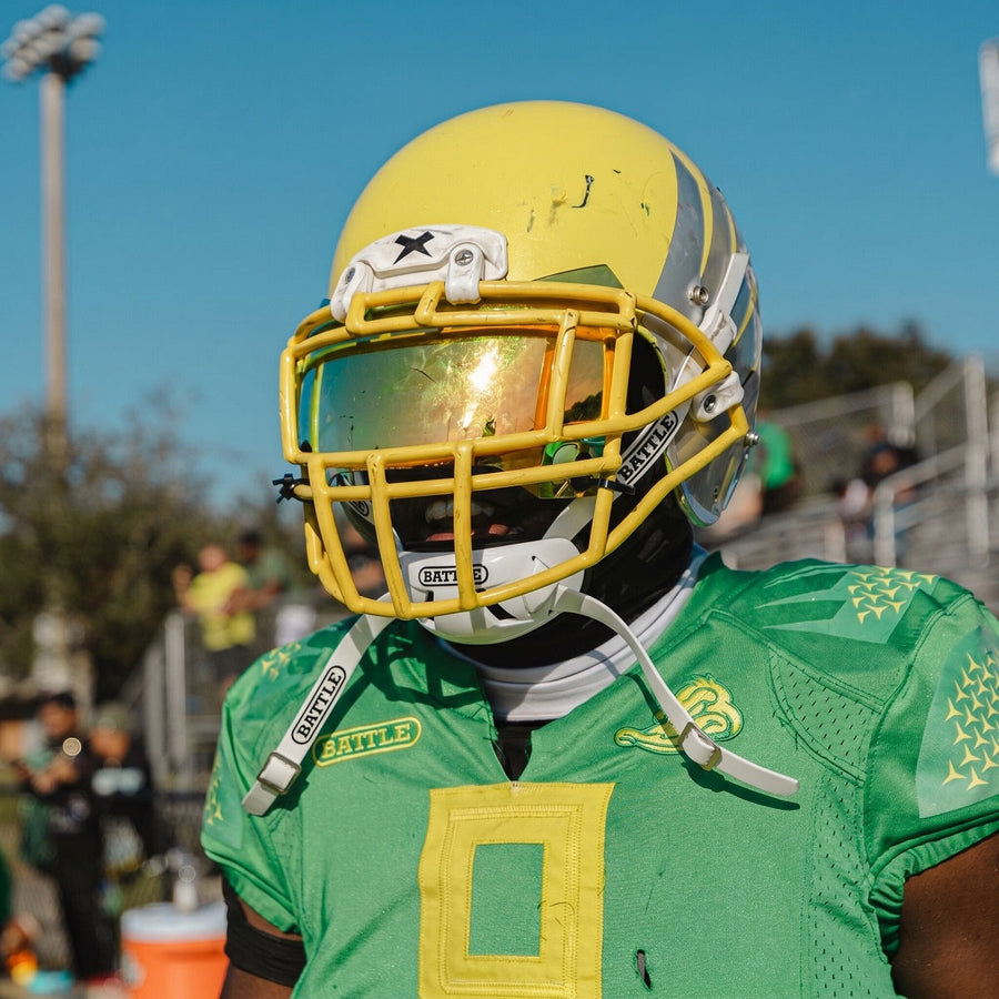 Football player wearing helmet with chin stap