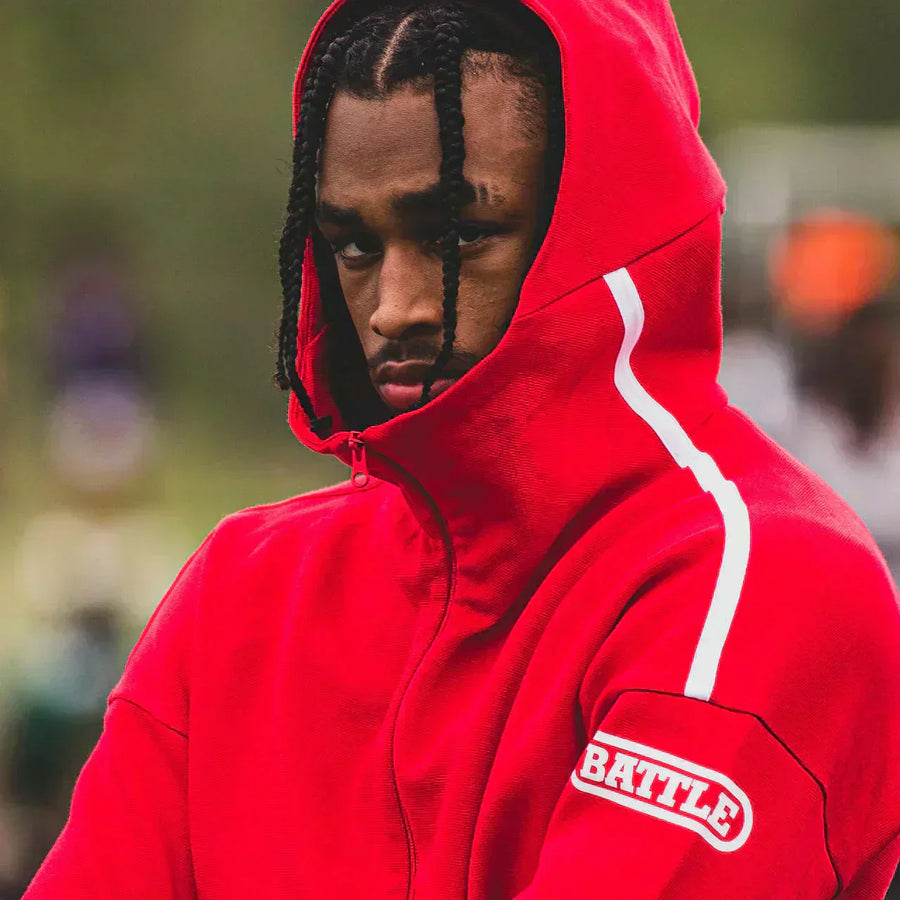 man wearing red Battle zip up jacket