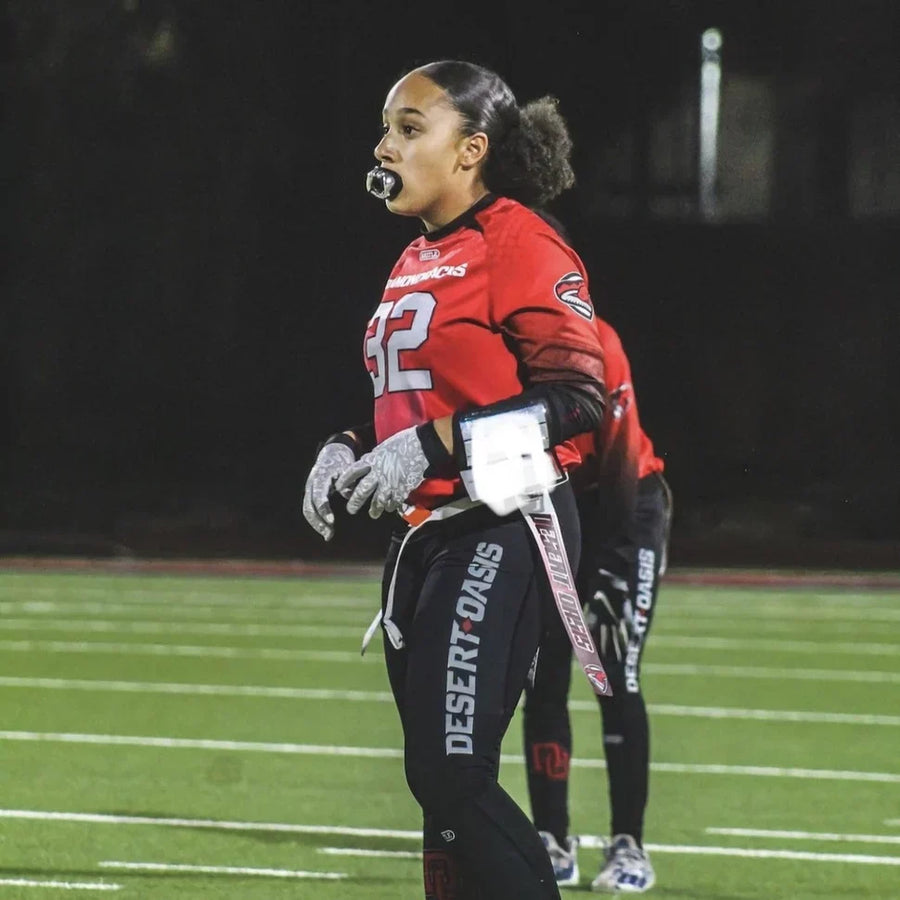 Female flag football player wearing Fangs Football Mouthguard