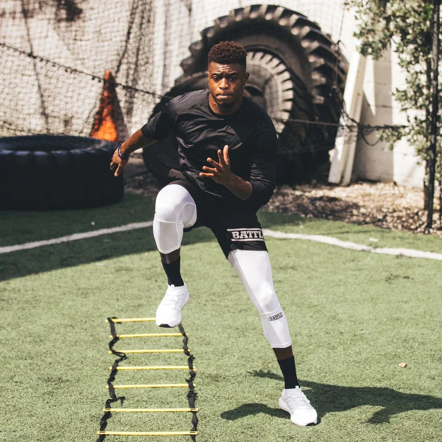 Football player running ladder drills for spring practice in new football apparel