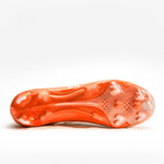 A pair of bright orange football cleats with white 'BATTLE', displayed on a clean white background.