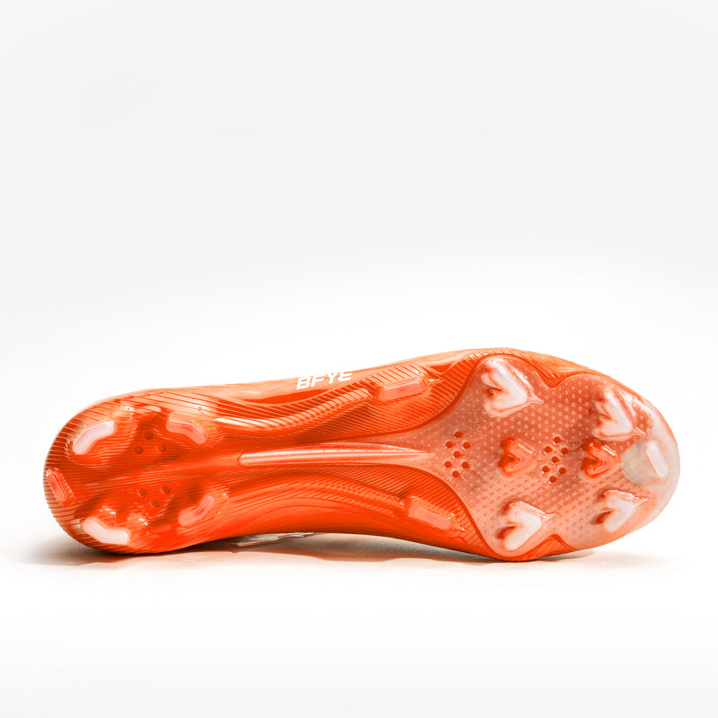 A pair of bright orange football cleats with white 'BATTLE', displayed on a clean white background.