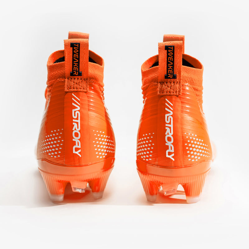 A pair of bright orange football cleats with white 'BATTLE', displayed on a clean white background.
