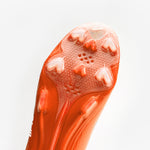 A pair of bright orange football cleats with white 'BATTLE', displayed on a clean white background.