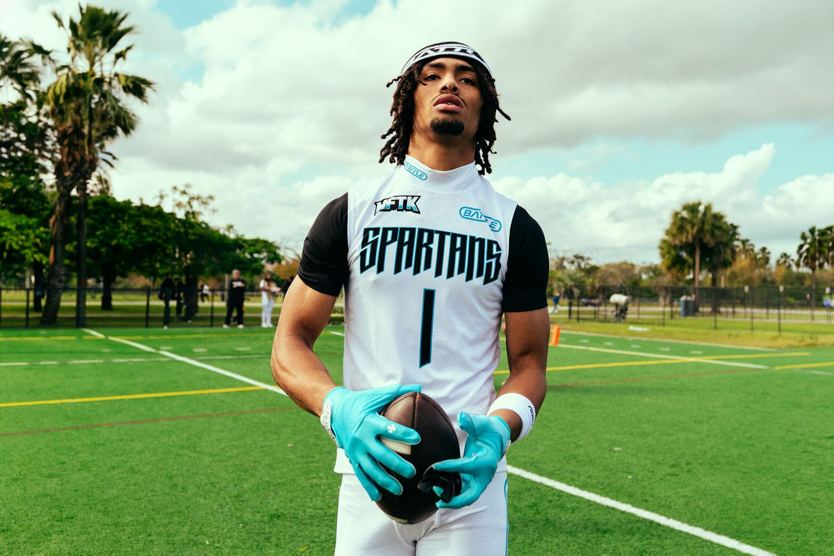 Brysen Wright in an MFTK Spartans number 1 jersey holding a football